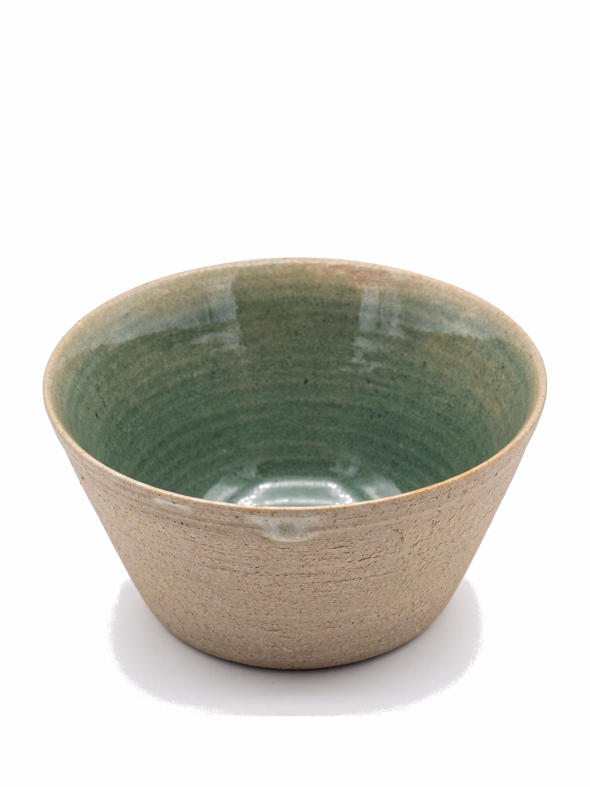 A flared bowl with a raw textured stoneware exterior and a pooling jade-green glazed interior.