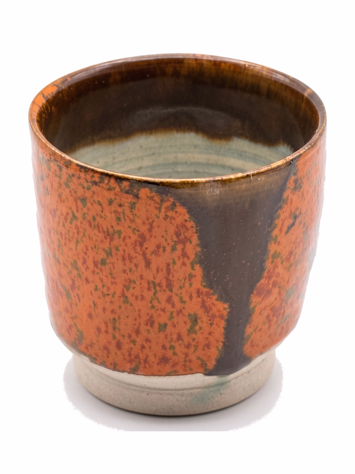 A short cup with a vivid iron-red glaze broken by a vertical dark stripe, on a raw stoneware foot.