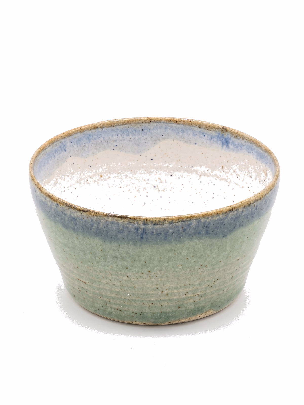 A flared bowl with a soft jade-green exterior, a cobalt blue band at the lip, and a cream speckled interior.